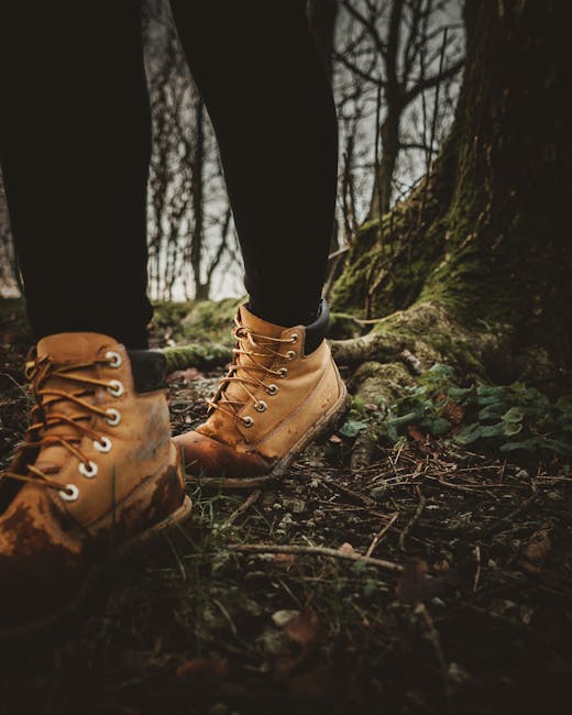 Close-up of hiking boots on a forest path during a nature walk.